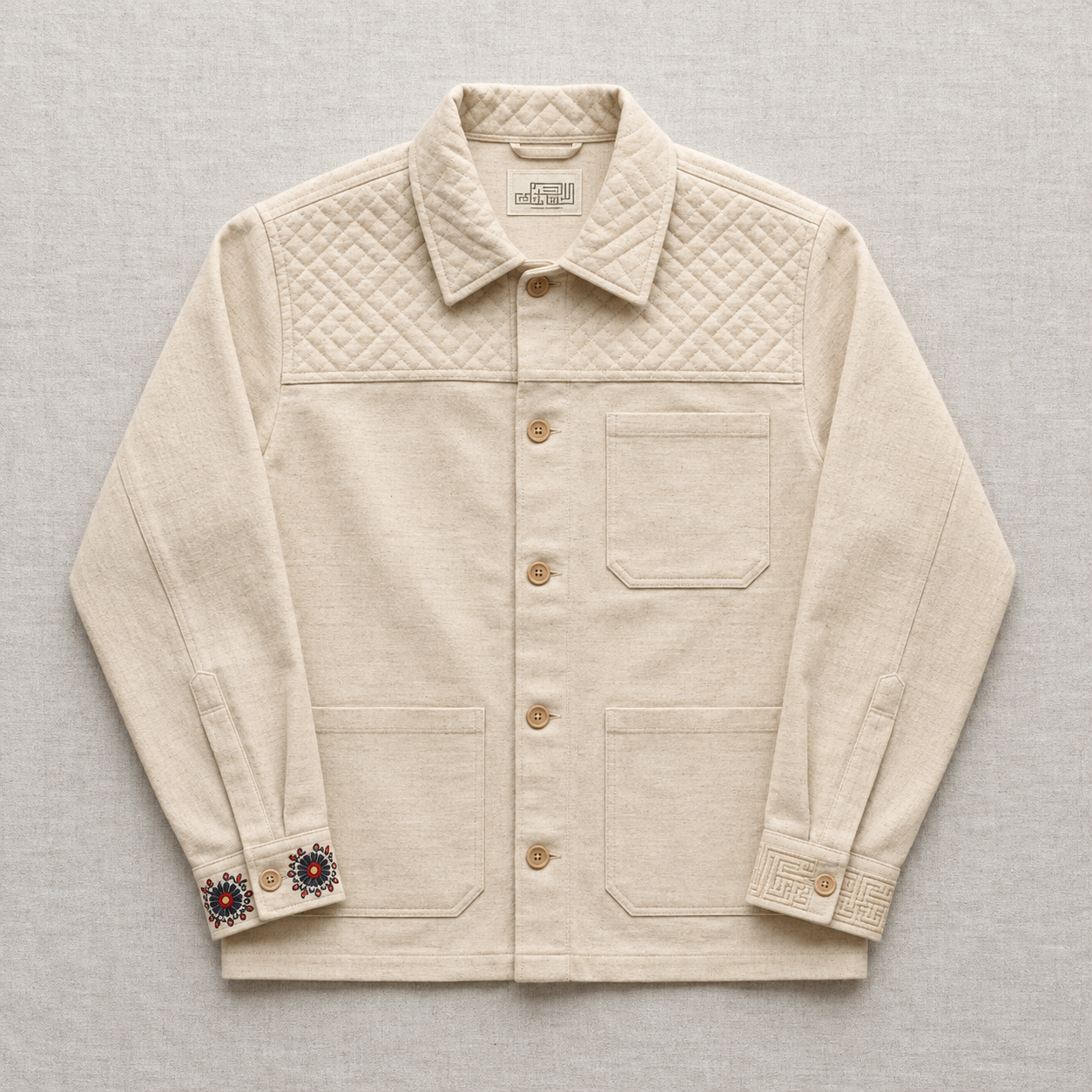 Ivory overshirt with diamond quilted shoulder panels and floral motifs at the cuffs